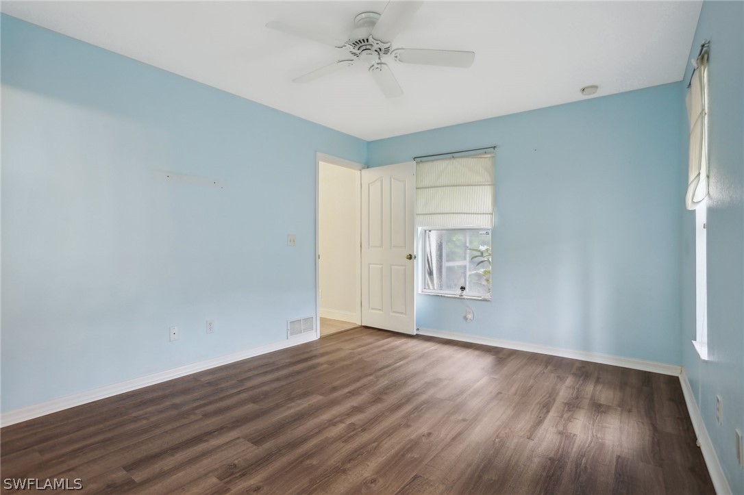 18364 Camellia Road Fort Myers, FL 33967 - Photo 18 of 48 an empty room with wooden floor and windows