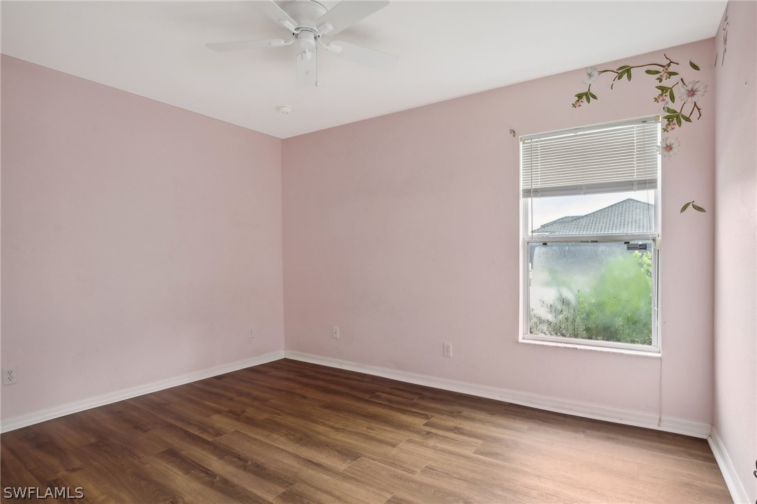 18364 Camellia Road Fort Myers, FL 33967 - Photo 23 of 48 a view of an empty room with wooden floor and a window
