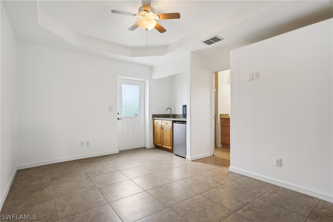 18364 Camellia Road Fort Myers, FL 33967 - Photo 24 of 48 a view of an empty room with a kitchen