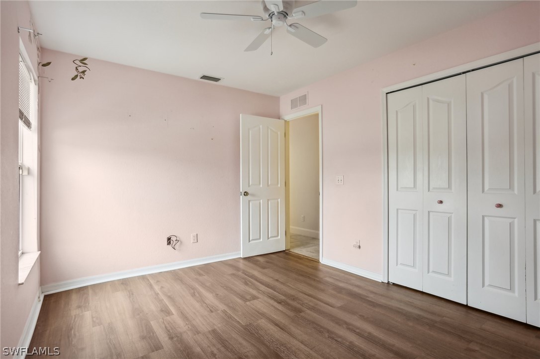 18364 Camellia Road Fort Myers, FL 33967 - Photo 25 of 48 a view of an empty room with wooden floor