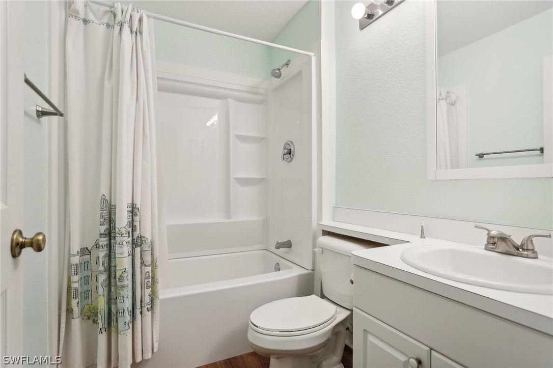 18364 Camellia Road Fort Myers, FL 33967 - Photo 28 of 48 a bathroom with a granite countertop sink toilet and shower
