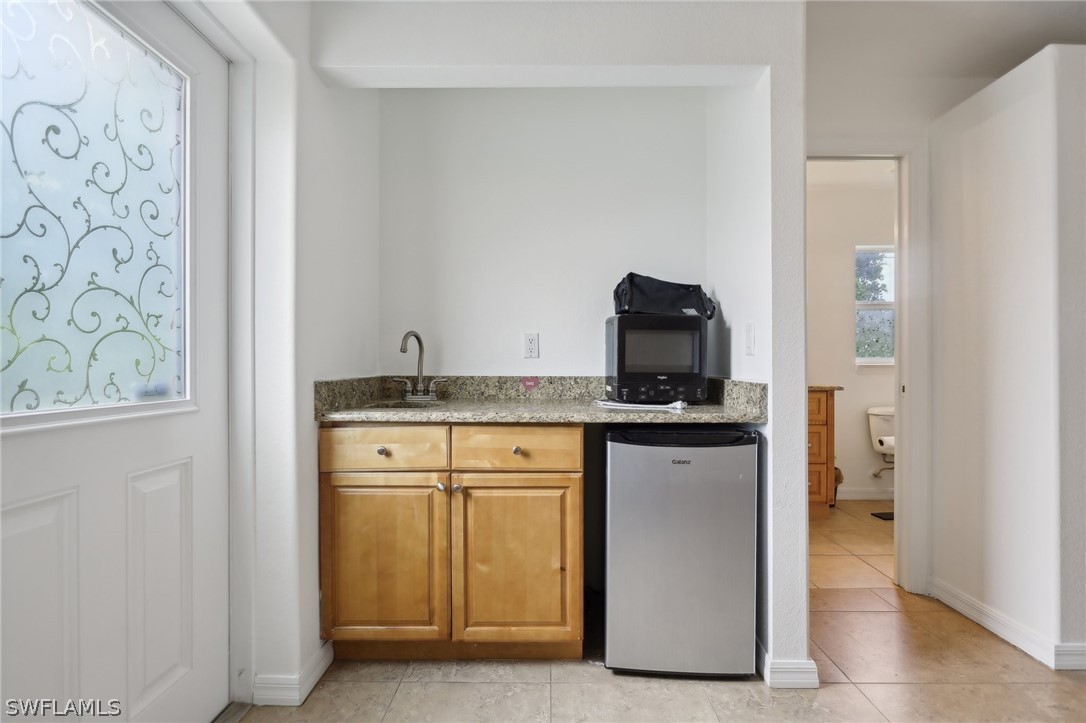 18364 Camellia Road Fort Myers, FL 33967 - Photo 32 of 48 a kitchen with stainless steel appliances granite countertop a stove and a refrigerator
