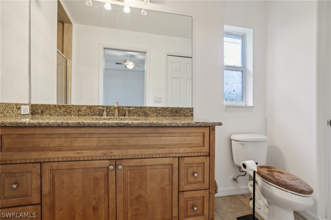 18364 Camellia Road Fort Myers, FL 33967 - Photo 35 of 48 a bathroom with a sink a toilet and mirror