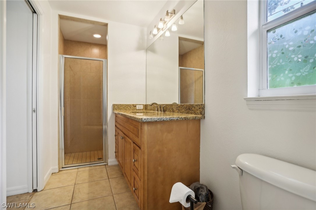 18364 Camellia Road Fort Myers, FL 33967 - Photo 36 of 48 a bathroom with a granite countertop sink a toilet and shower
