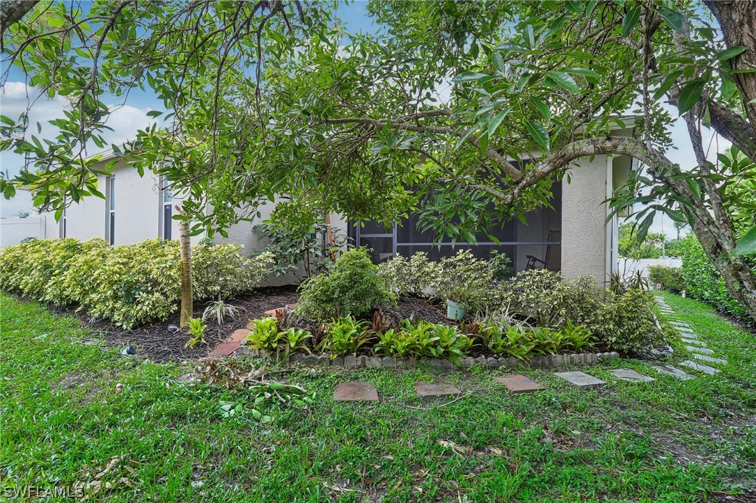 18364 Camellia Road Fort Myers, FL 33967 - Photo 41 of 48 a view of a garden with plants and large trees