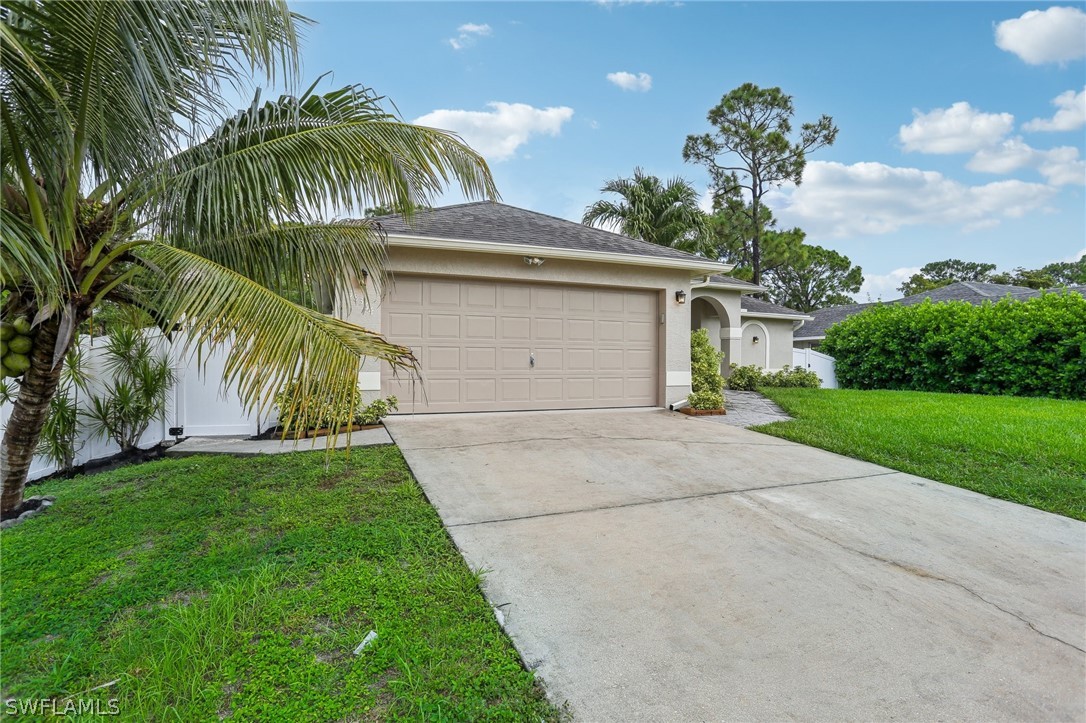18364 Camellia Road Fort Myers, FL 33967 - Photo 46 of 48 a view of a house with a yard and palm trees