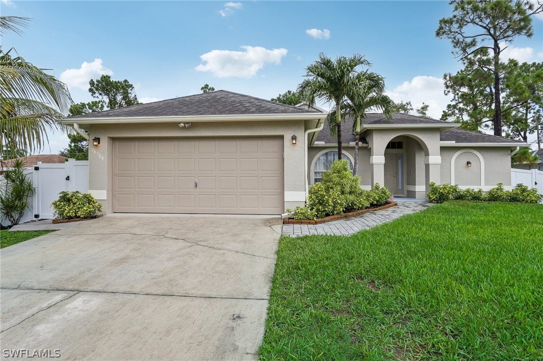 18364 Camellia Road Fort Myers, FL 33967 - Photo 47 of 48 a front view of a house with garden