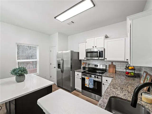 a view of kitchen and center island with wooden floor
