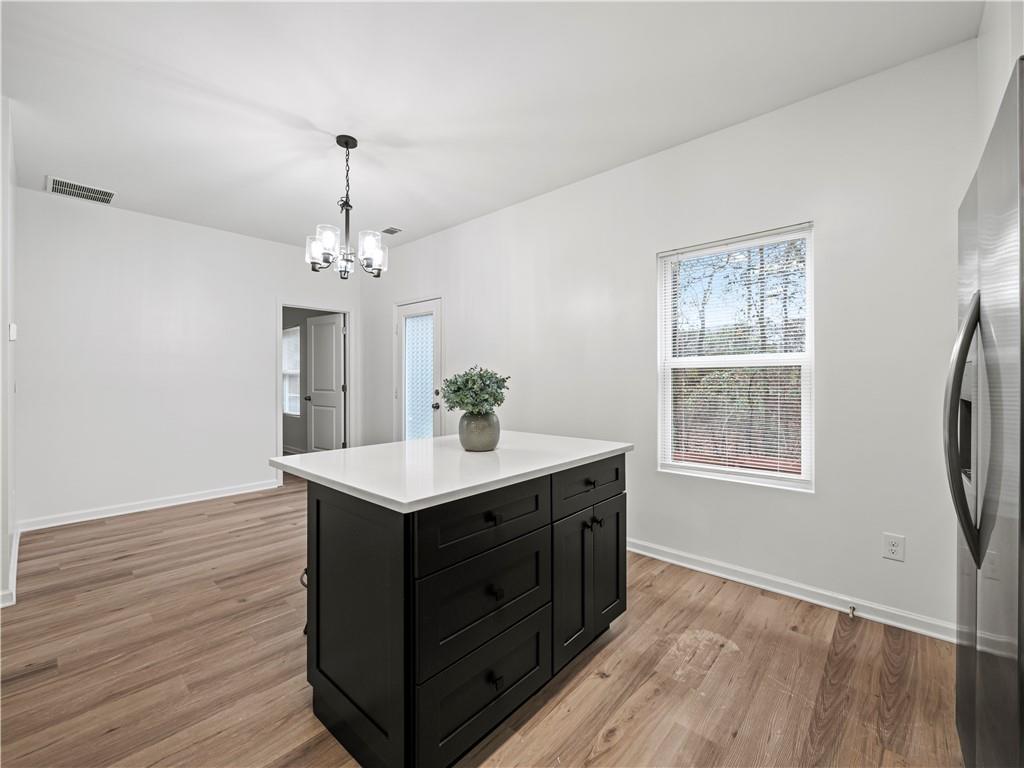 4334 Box Elder Path Gainesville, GA 30504 - Photo 13 of 39 a view of kitchen and center island with wooden floor