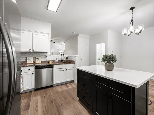 a kitchen with a refrigerator and microwave