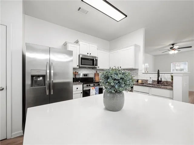 a view of a dining room with furniture wooden floor and chandelier