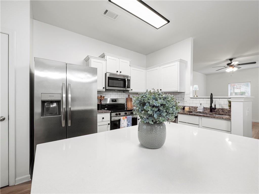 4334 Box Elder Path Gainesville, GA 30504 - Photo 15 of 39 a kitchen with a refrigerator and microwave