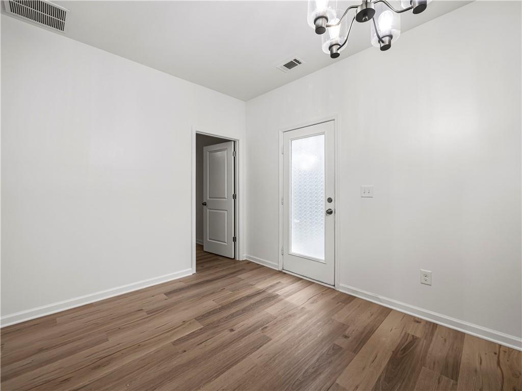 4334 Box Elder Path Gainesville, GA 30504 - Photo 18 of 39 a view of an empty room with wooden floor