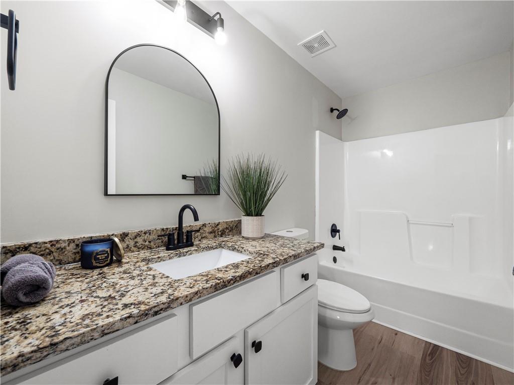 4334 Box Elder Path Gainesville, GA 30504 - Photo 19 of 39 a bathroom with a granite countertop sink and a mirror