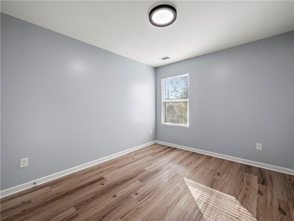 4334 Box Elder Path Gainesville, GA 30504 - Photo 21 of 39 an empty room with wooden floor and windows