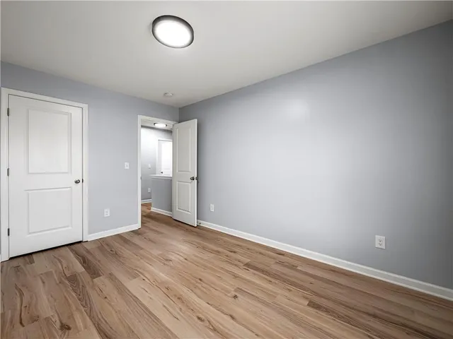 a view of a room with wooden floor