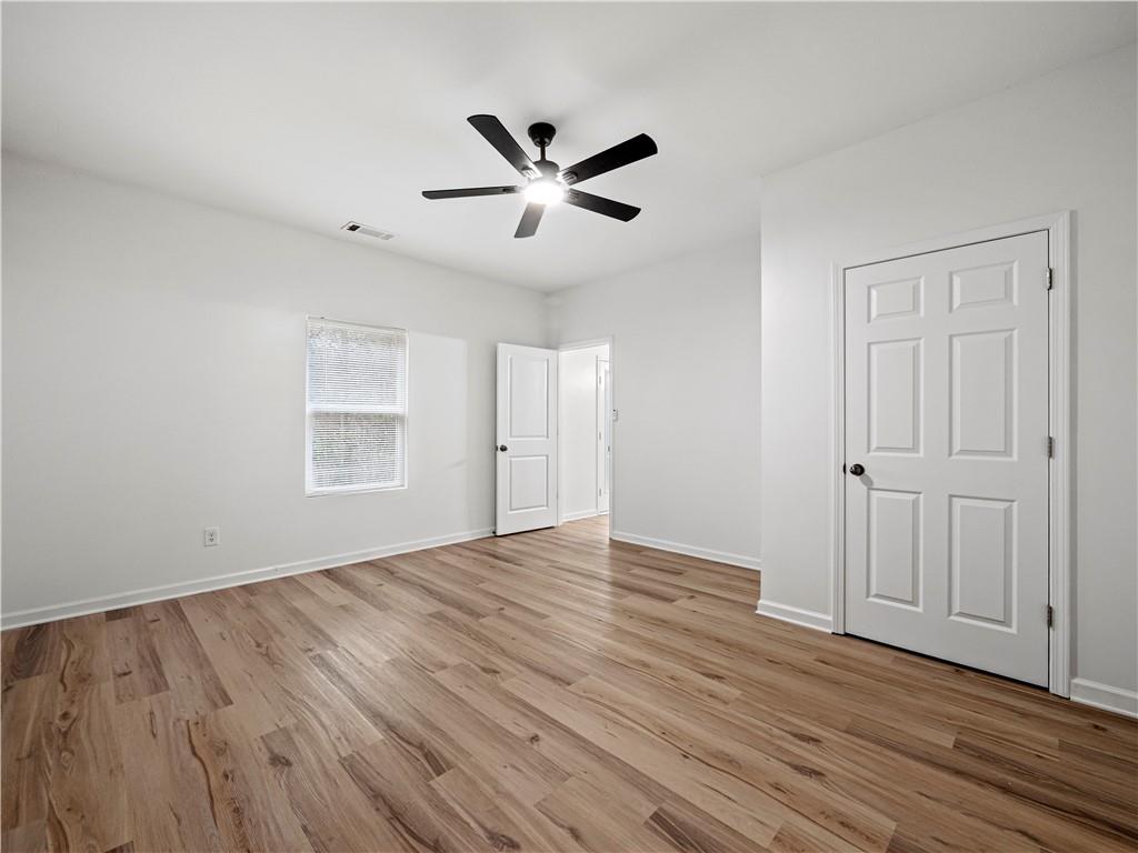 4334 Box Elder Path Gainesville, GA 30504 - Photo 26 of 39 an empty room with wooden floor closet and windows