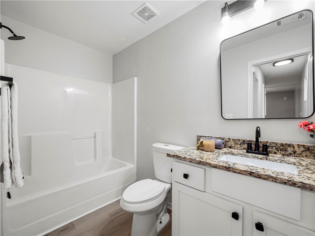 4334 Box Elder Path Gainesville, GA 30504 - Photo 27 of 39 a bathroom with a granite countertop sink mirror vanity and toilet