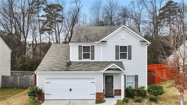 a front view of a house with garage