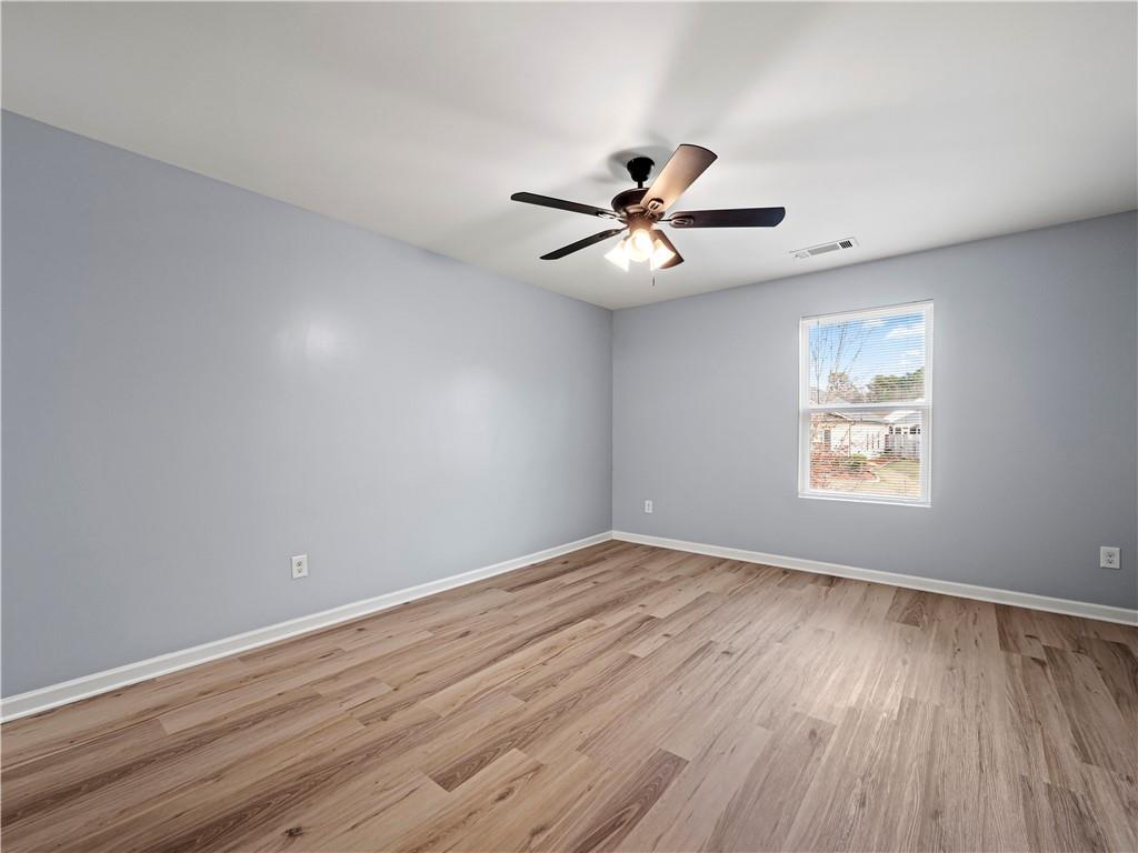 4334 Box Elder Path Gainesville, GA 30504 - Photo 33 of 39 a view of an empty room with wooden floor and a window