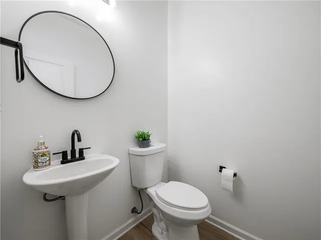 a view of a room with wooden floor and windows