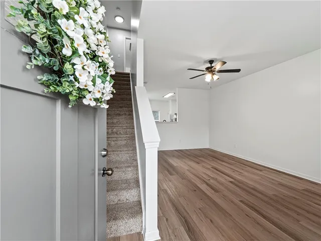 a view of entryway and hall with wooden floor