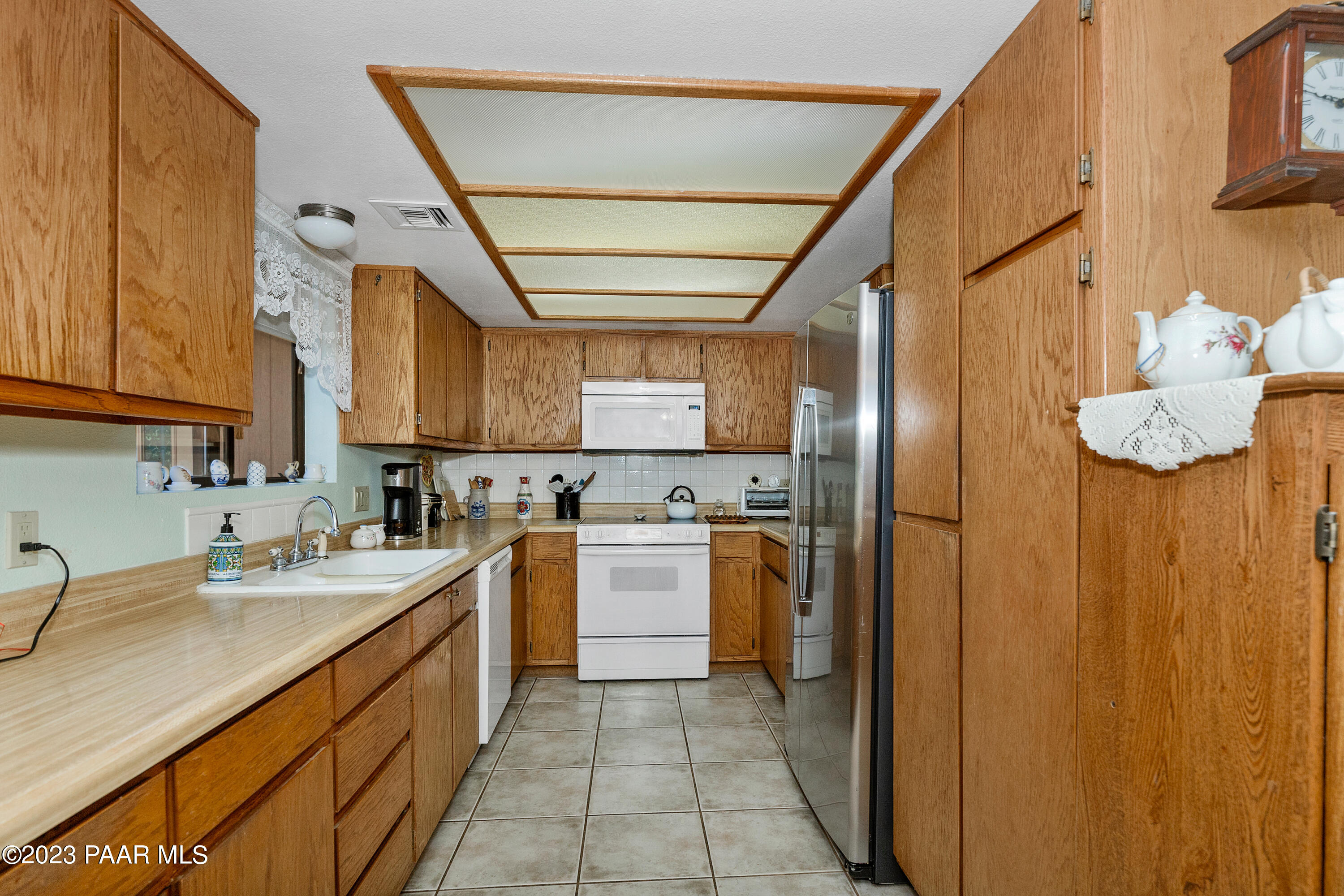 2680 Ridge Road Prescott, AZ 86301 - Photo 7 of 25 a kitchen with stainless steel appliances granite countertop a sink refrigerator and cabinets