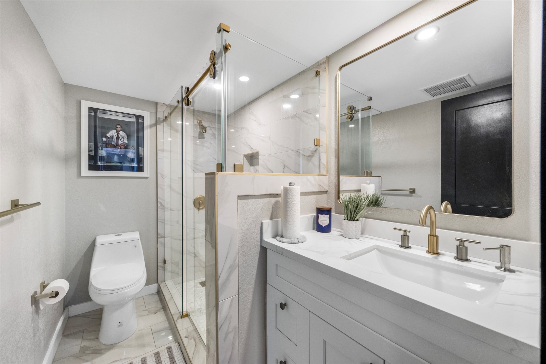 3525 Sage Road, Unit 1403 Houston, TX 77056 - Photo 28 of 47 a bathroom with a sink a toilet a mirror and shower