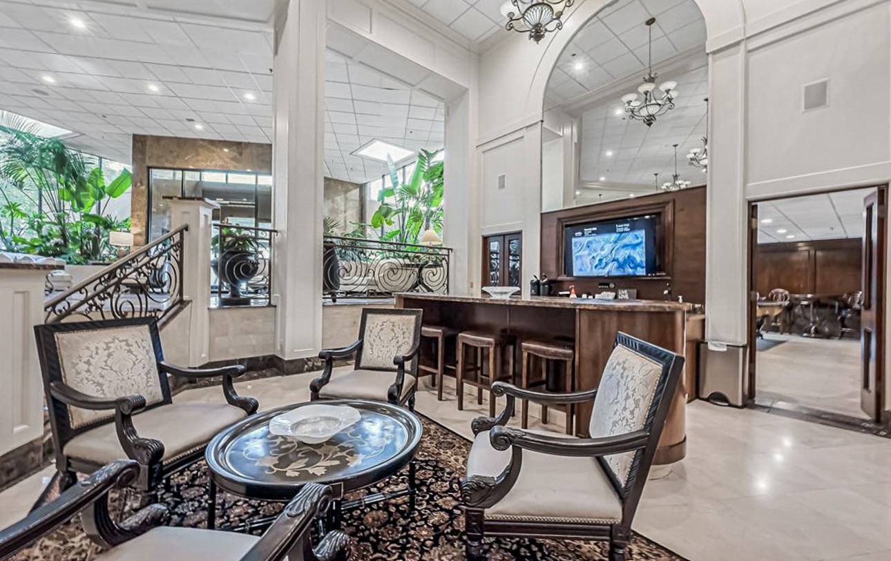 3525 Sage Road, Unit 1403 Houston, TX 77056 - Photo 45 of 47 a dining room with furniture a rug and a chandelier