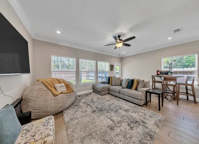 a living room with furniture and a chandelier