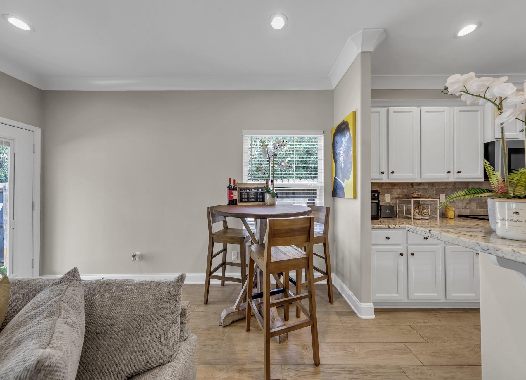 1200 French Quarter Way Fort Walton Beach, FL 32547 - Photo 16 of 45 a kitchen with stainless steel appliances kitchen island granite countertop a table and chairs in it