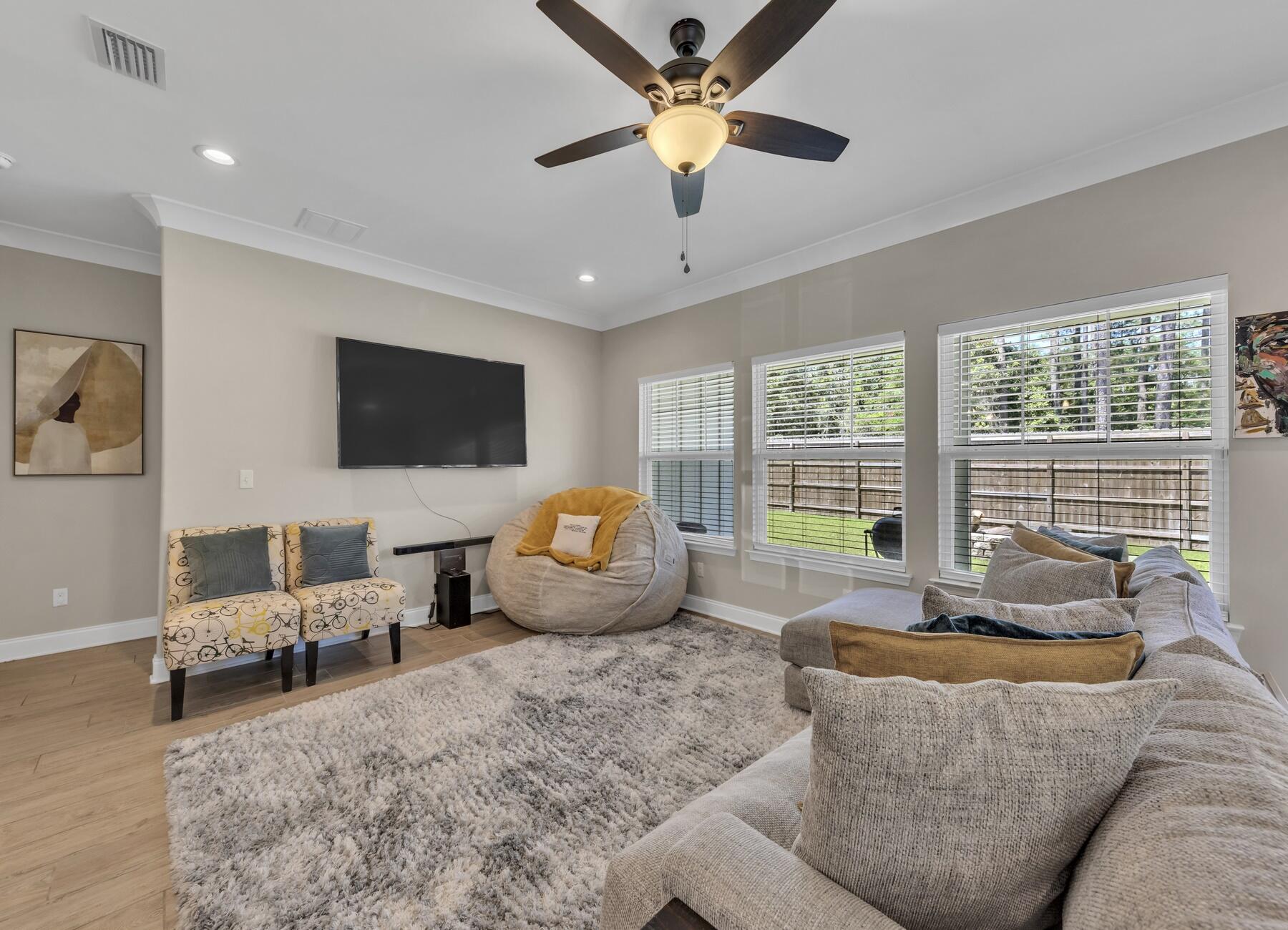 1200 French Quarter Way Fort Walton Beach, FL 32547 - Photo 18 of 45 a living room with furniture floor to ceiling window and a flat screen tv