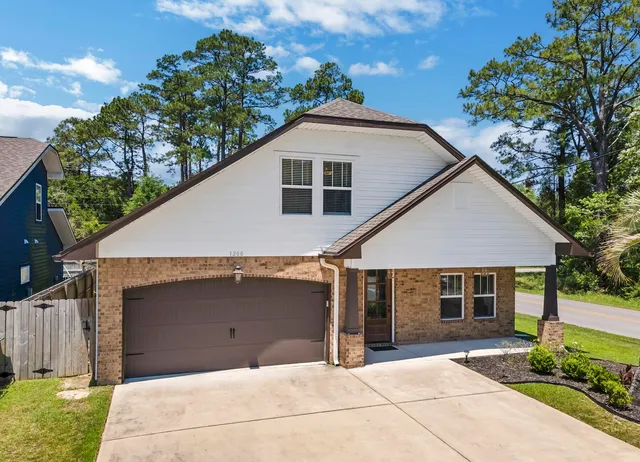 a front view of a house with a garden