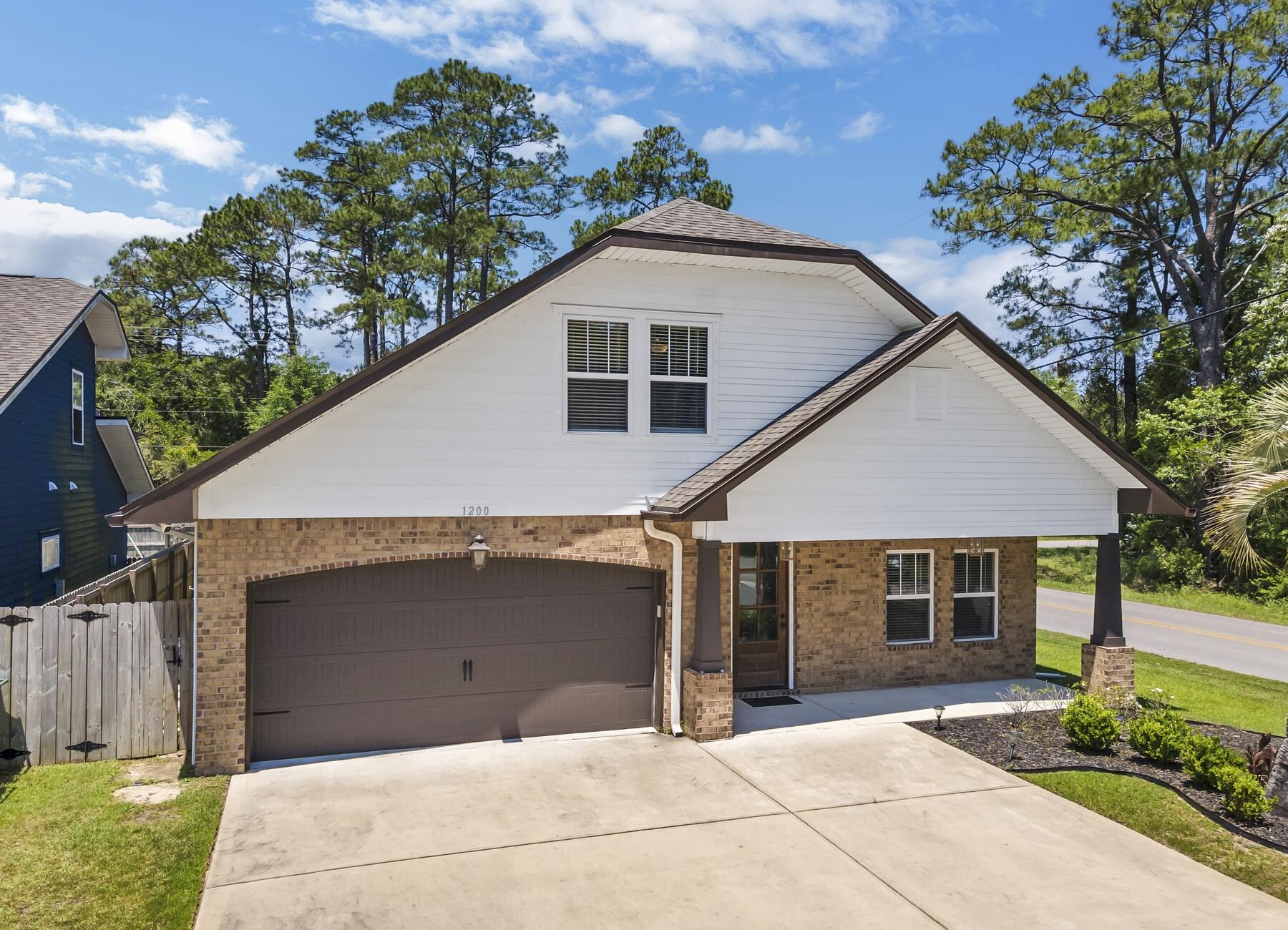 1200 French Quarter Way Fort Walton Beach, FL 32547 - Photo 2 of 45 a front view of a house with a garden