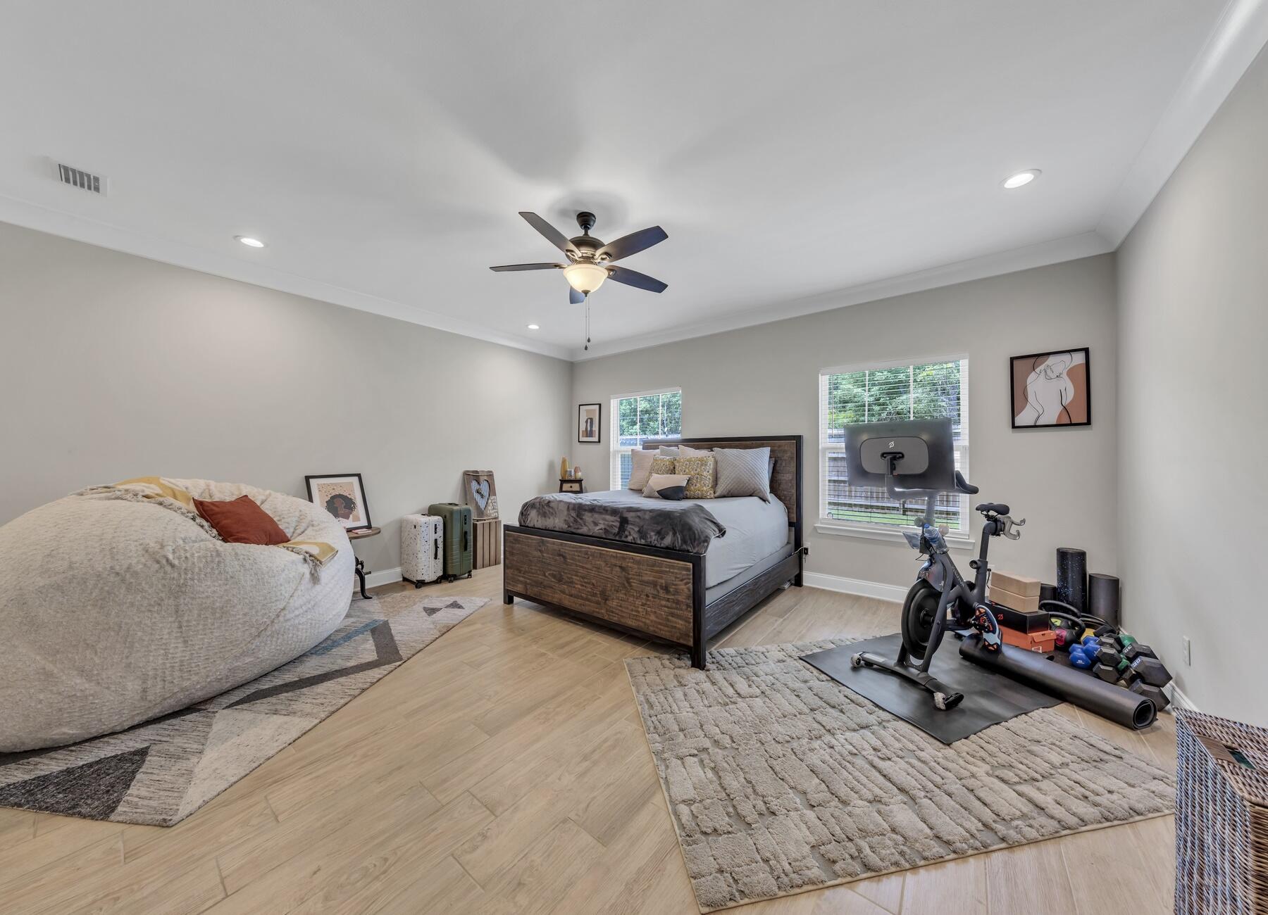 1200 French Quarter Way Fort Walton Beach, FL 32547 - Photo 30 of 45 a spacious bedroom with a bed a couch and a chandelier