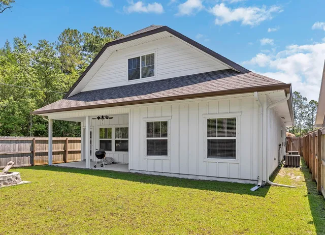 a swimming pool with outdoor seating and yard