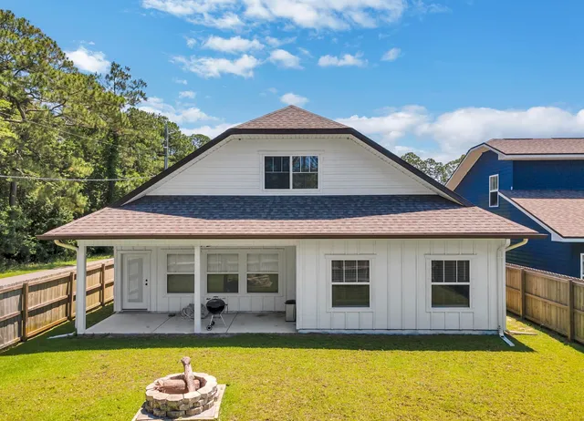 a front view of house with yard outdoor seating and barbeque oven