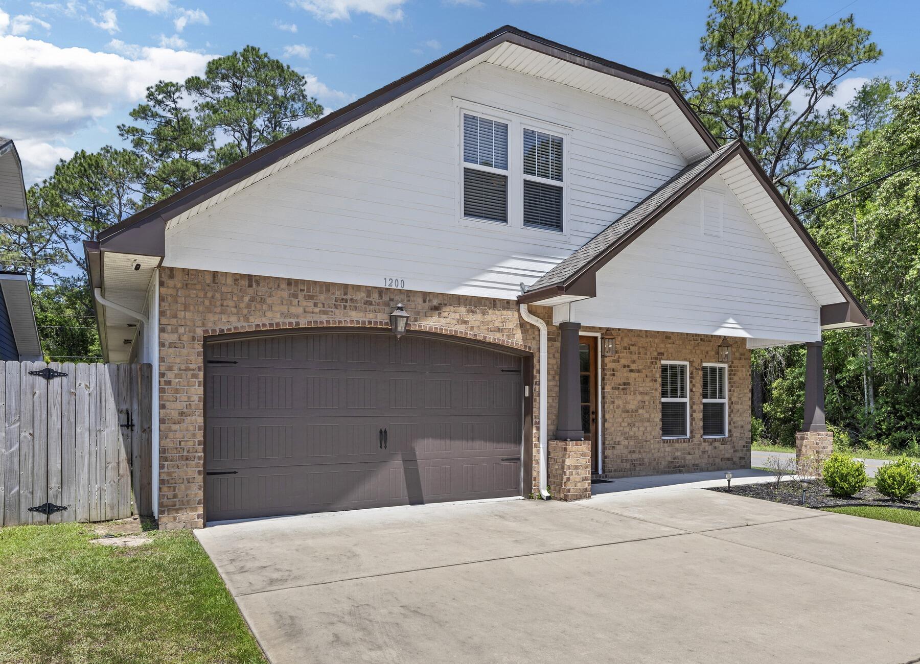 1200 French Quarter Way Fort Walton Beach, FL 32547 - Photo 5 of 45 a front view of a house with a garage