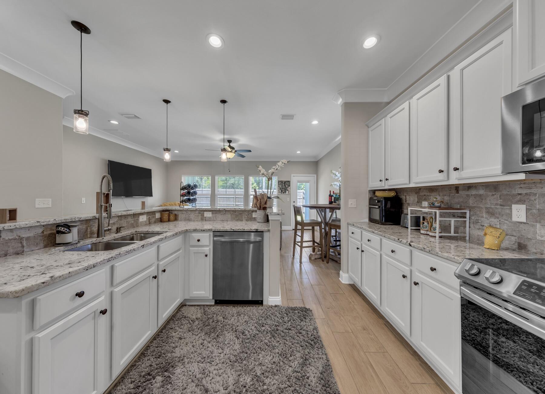 1200 French Quarter Way Fort Walton Beach, FL 32547 - Photo 6 of 45 a kitchen with a sink stove and cabinets