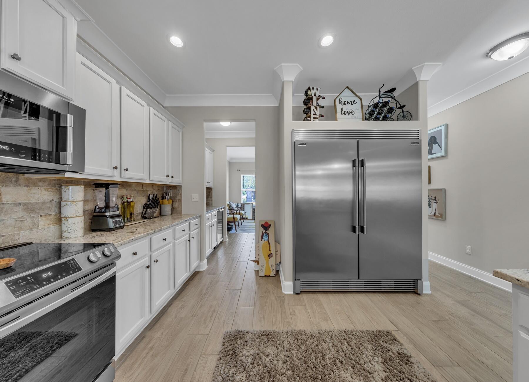 1200 French Quarter Way Fort Walton Beach, FL 32547 - Photo 7 of 45 a kitchen with stainless steel appliances granite countertop a refrigerator a stove and a sink with wooden floor