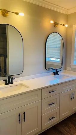 a bathroom with a double vanity sink and a mirror