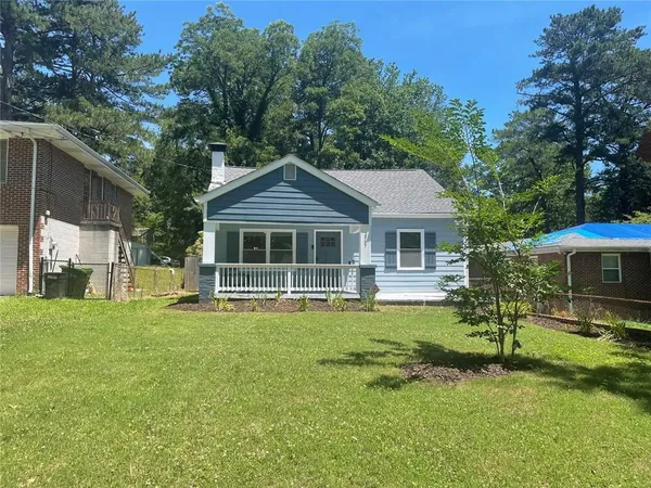 a front view of a house with a garden