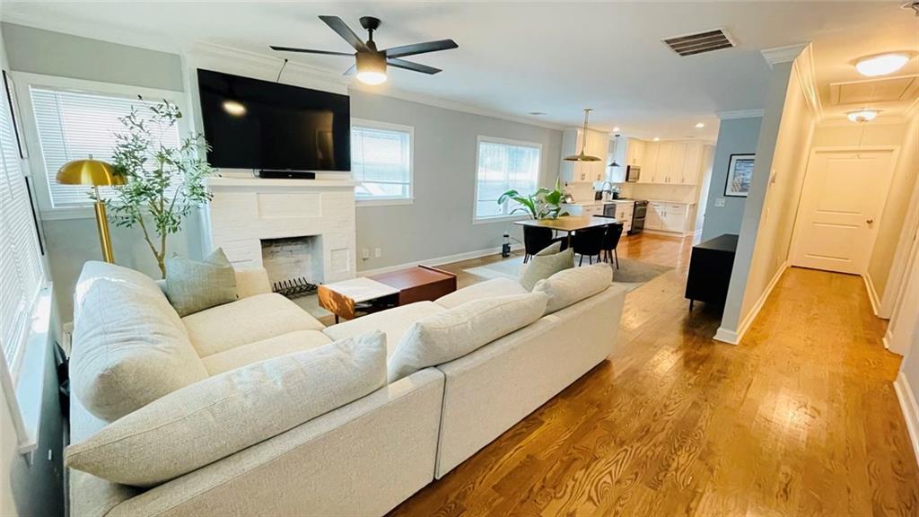 2507 Ryne Street Northwest Atlanta, GA 30318 - Photo 3 of 15 a living room with furniture a flat screen tv and a fireplace