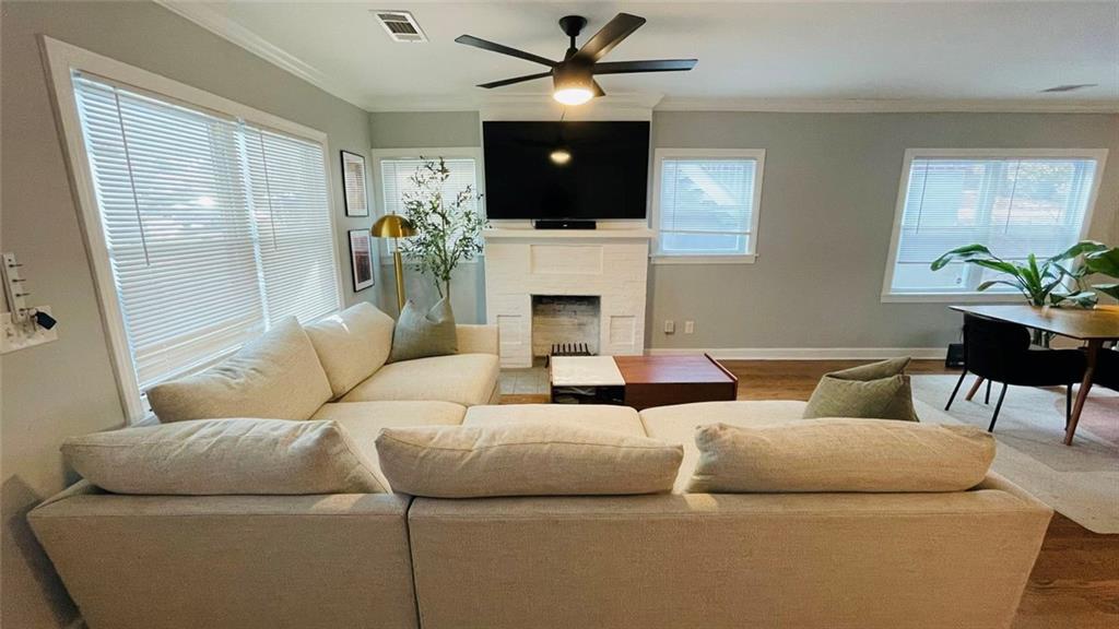 2507 Ryne Street Northwest Atlanta, GA 30318 - Photo 4 of 15 a living room with furniture a flat screen tv and a fireplace