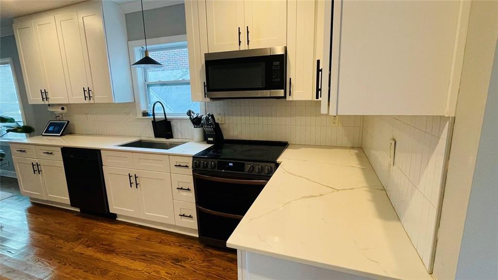 2507 Ryne Street Northwest Atlanta, GA 30318 - Photo 6 of 15 a kitchen with a sink and a stove top oven