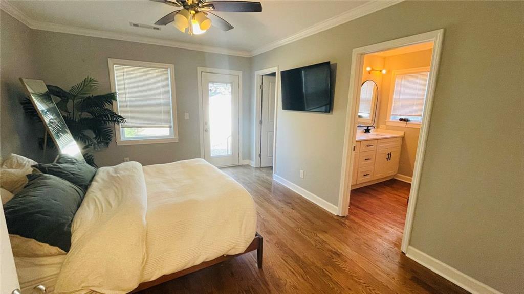 2507 Ryne Street Northwest Atlanta, GA 30318 - Photo 10 of 15 a bedroom with a bed and a chandelier