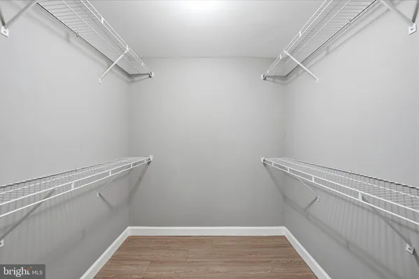 a view of walk in closet with empty racks