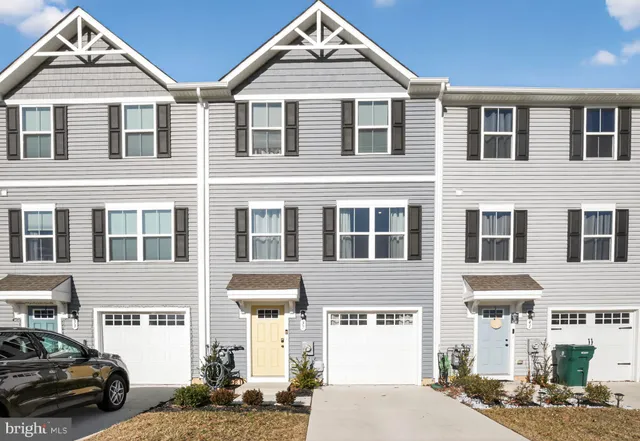 a front view of a residential apartment building with a yard