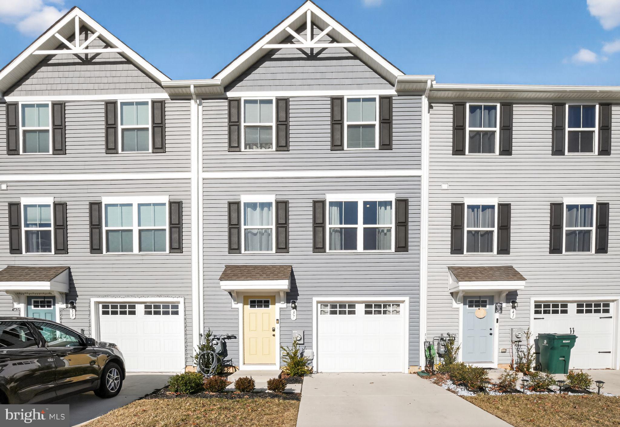a front view of a residential apartment building with a yard