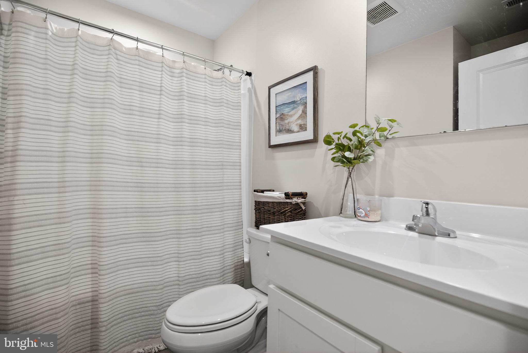 37 Riley Street Williamstown, NJ 08094 - Photo 12 of 15 a bathroom with a sink a toilet and mirror